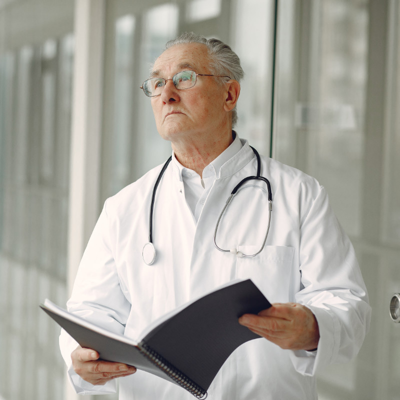 Older doctor with black book